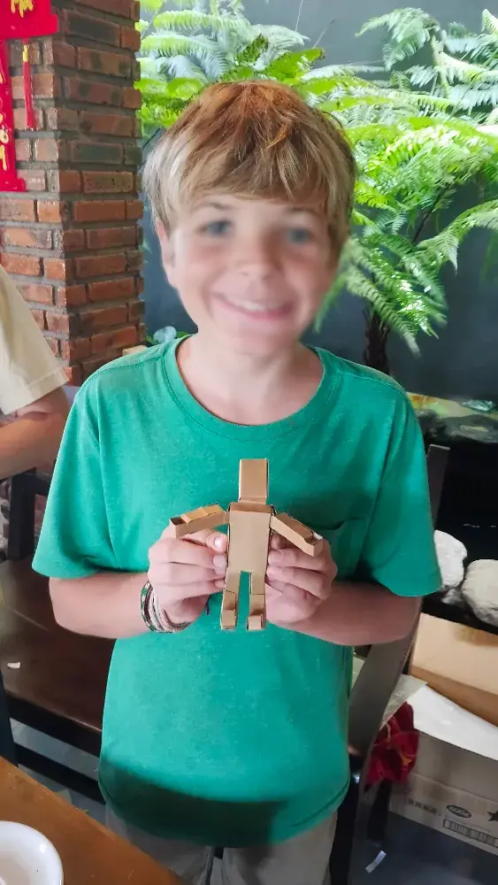 Student testing a cardboard mechanism